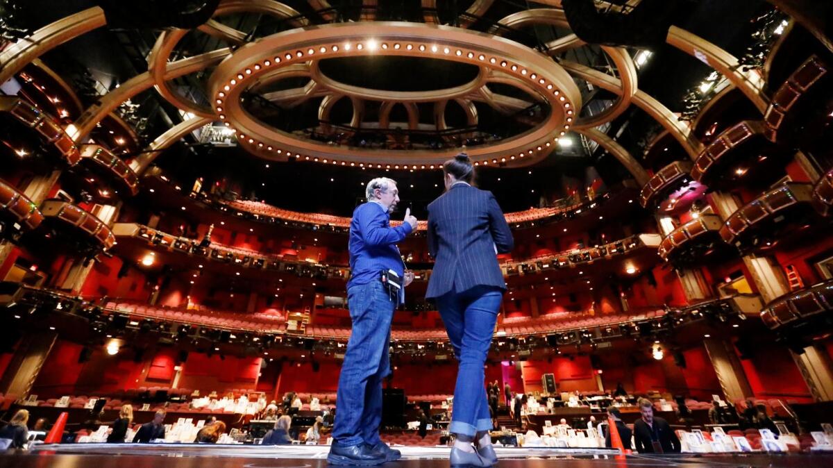 Stage manager Gary Natoli, left, talks with art director Alana Billingsley on stage during rehearsals for the 89th Academy Awards in Hollywood's Dolby Theatre.