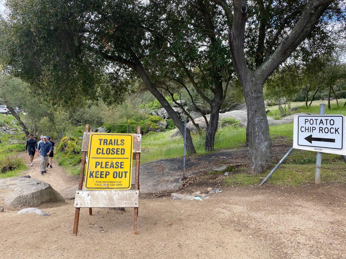 Hikers parked along SR-67 Tuesday, March 24, ignored Mt. Woodson trail closure signs, many saying they needed to get out to stop going stir crazy from shelter-in-place.