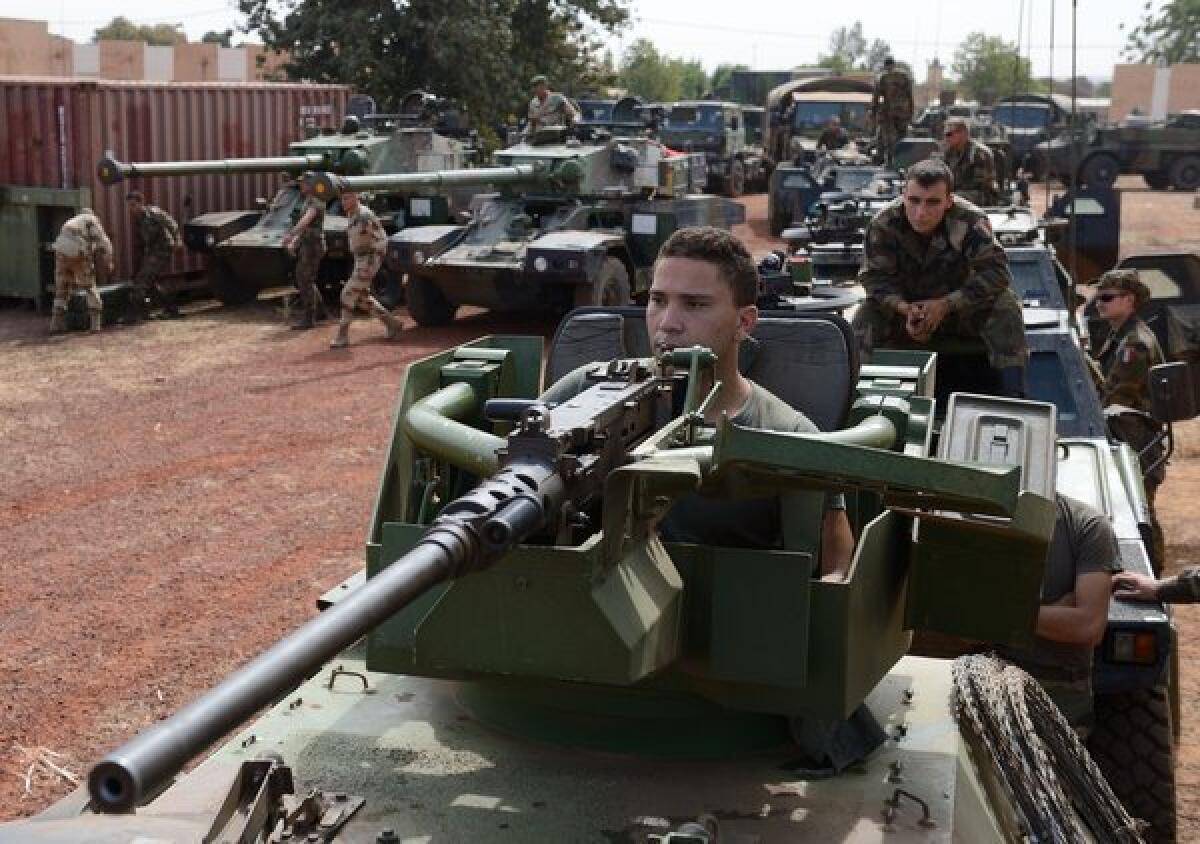 French soldiers ride armored vehicles and tanks Tuesday at a military airbase near Bamako, Mali's capital.