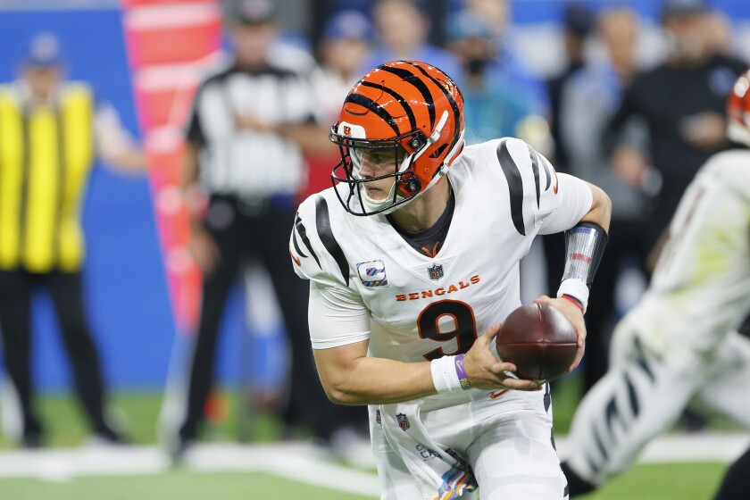 Cincinnati Bengals quarterback Joe Burrow hands off during the second half against the Detroit Lions.