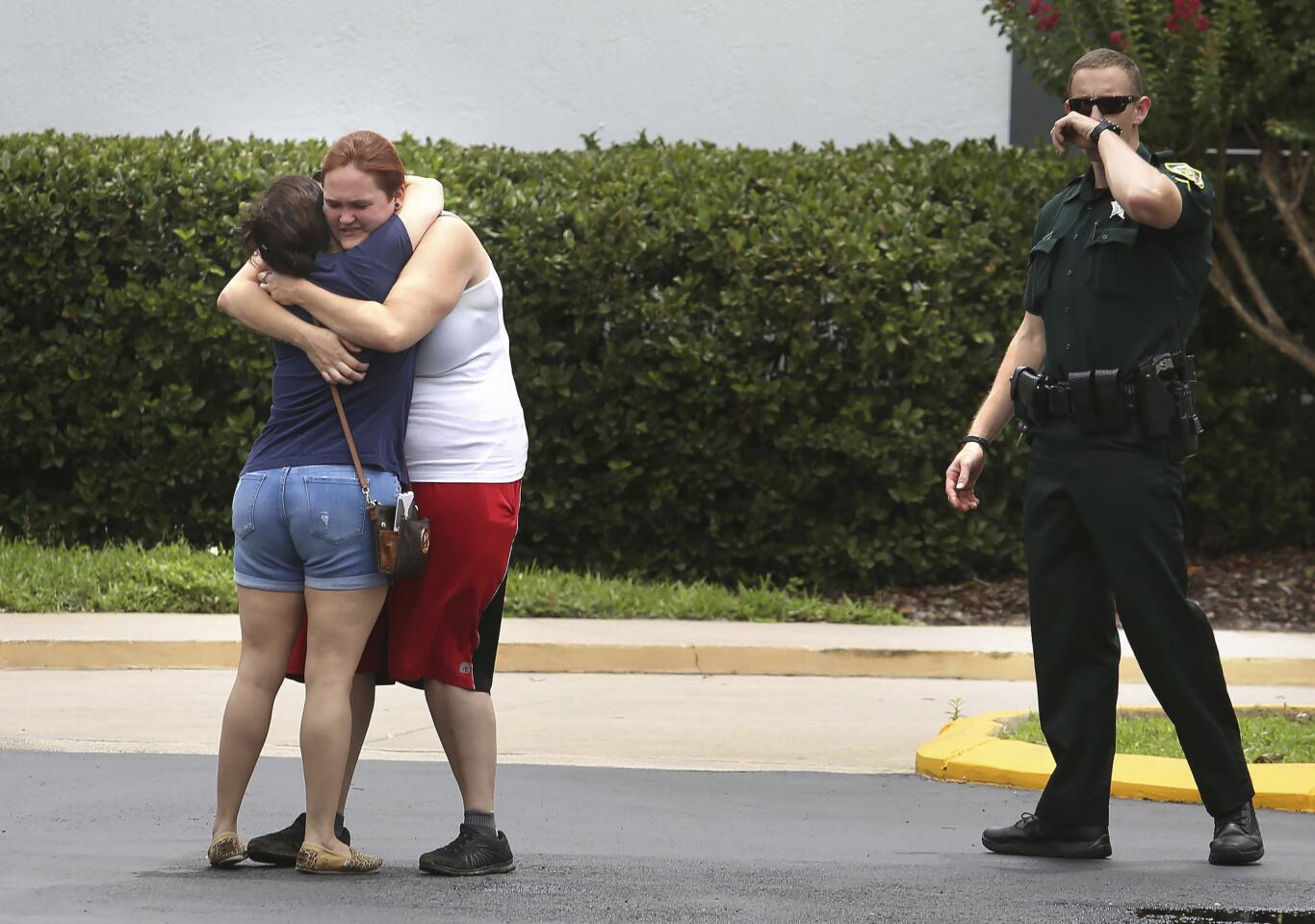 People console each other after a deadly shooting on June 5, 2017, in Orlando, Fla.