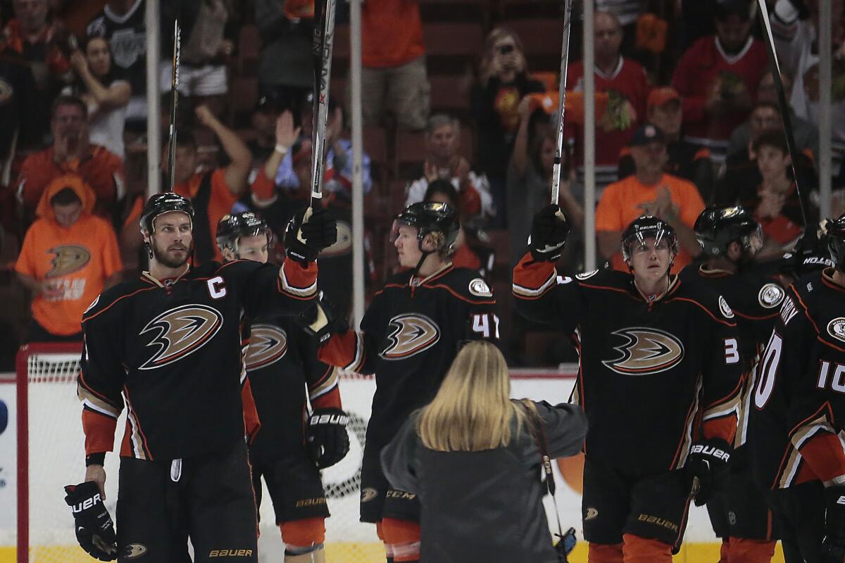Ducks captain Ryan Getzlaf joins teammates in a salute to fans after losing, 5-2, to the Chicago Blackhawks in Game 7 of the Western Conference finals at the Honda Center.