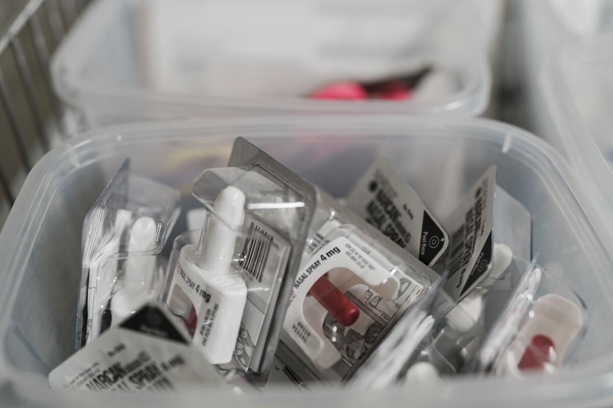 A bin containing packets of naloxone, which reverses opioid overdoses.