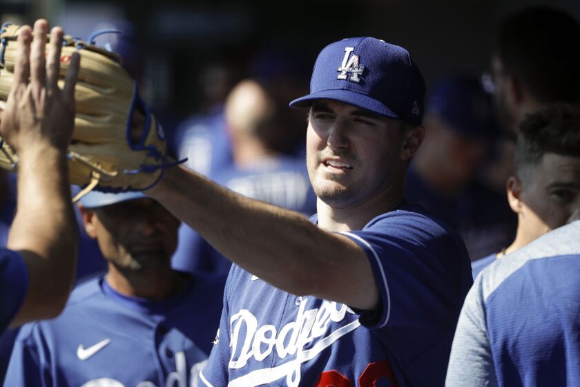 Los Angeles Dodgers starting pitcher Ross Stripling is greeted in the dugout.
