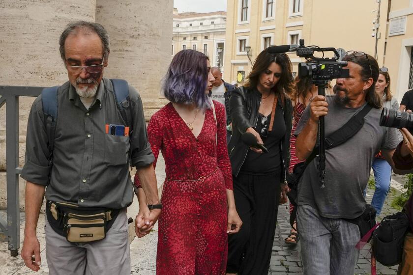 FILE - Ultima Generazione (Last Generation) activists Ester Goffi, second from left, and Guido Viero, left, arrive at The Vatican, Wednesday, May 24, 2023, where they are on trial for having staged a protest in August inside the Vatican Museums. A Vatican court on Monday, June 12, 2023, convicted the two environmental activists of aggravated damage and ordered them to pay more than 28,000 euros (US$30,000) in damages after they glued their hands to the base of an ancient statue in the Vatican Museums in a protest to draw attention to climate change. (AP Photo/Alessandra Tarantino, File)