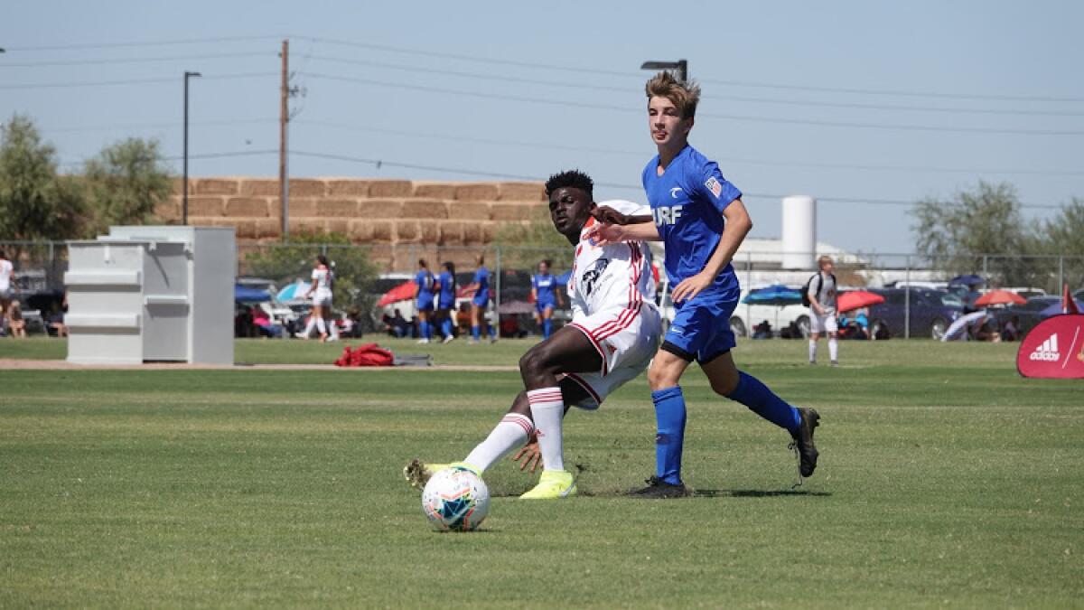 Dane Peterson, right, marks his man in a boys' 14-and-under soccer match while playing for the O.C. Surf.