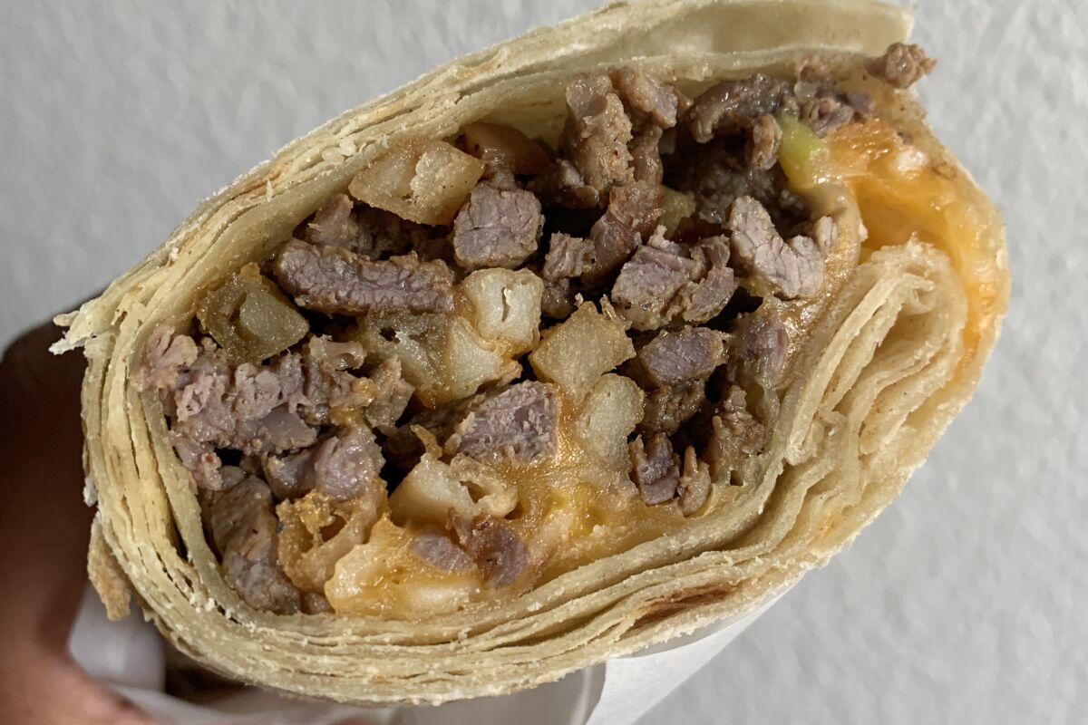 cross section of California burrito with fries, cheese and beef