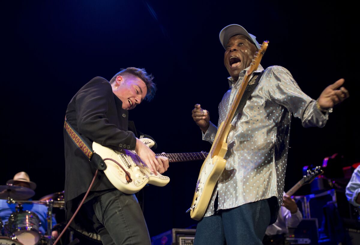 Two guitarists perform in the documentary “The Torch.”