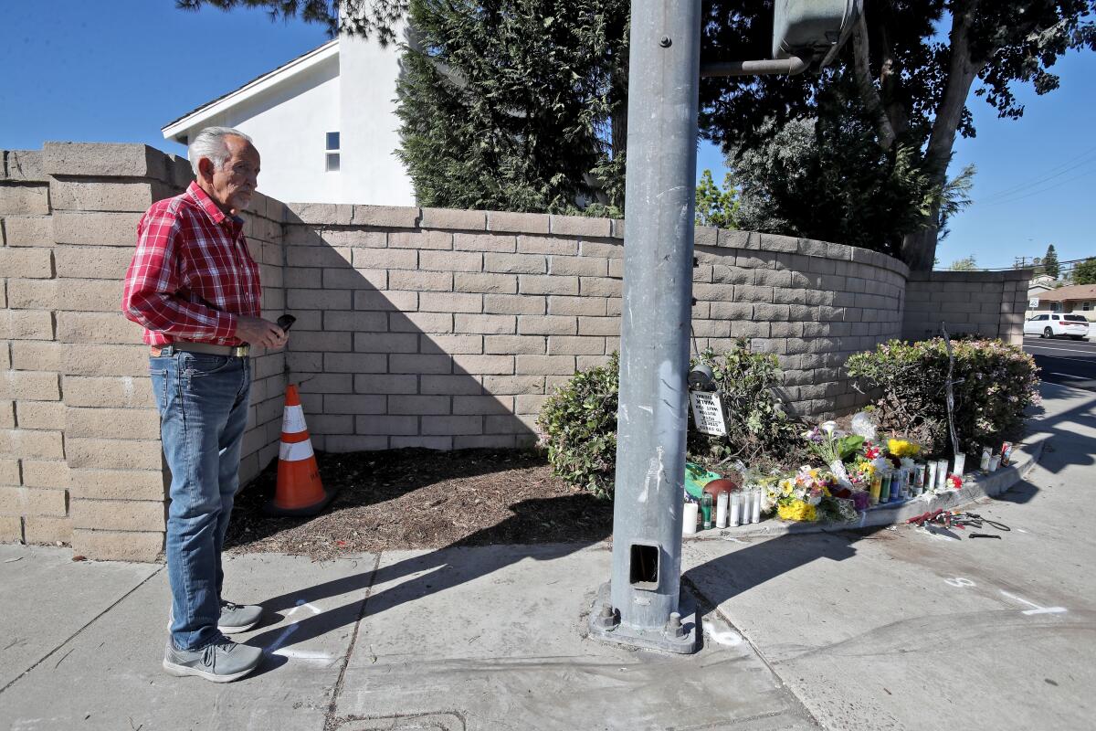 Anthony Yturralde stops by at growing memorial of candles and flowers for Josh and Jeremy Page.