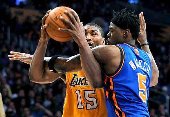 Lakers forward Metta World Peace is fouled by Knicks forward Bill Walker on a drive to the basket in the first quarter Thursday night at the Staples Center.