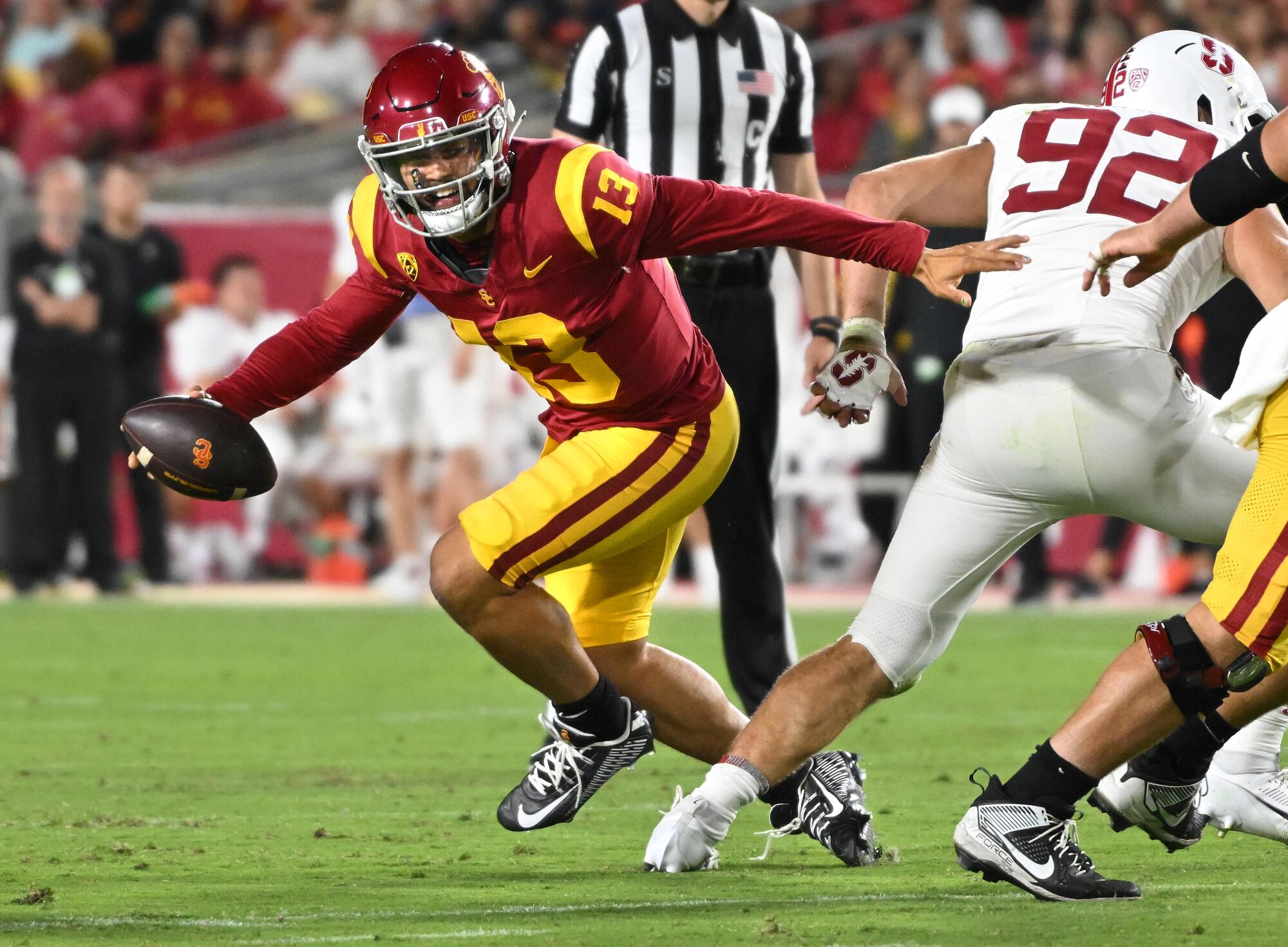 USC quarterback Caleb Williams scrambles before completing a pass against Stanford.