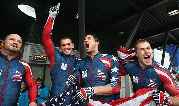 USA-1 team members (from left) Steve Holcomb, Justin Olsen, Steve Mesler and Curtis Tomasevicz celebrate after clinching the gold medal in four-man bobsled on Saturday at the Whistler Sliding Center.