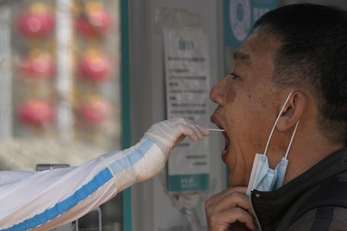 A man has his throat swabbed for a COVID test 