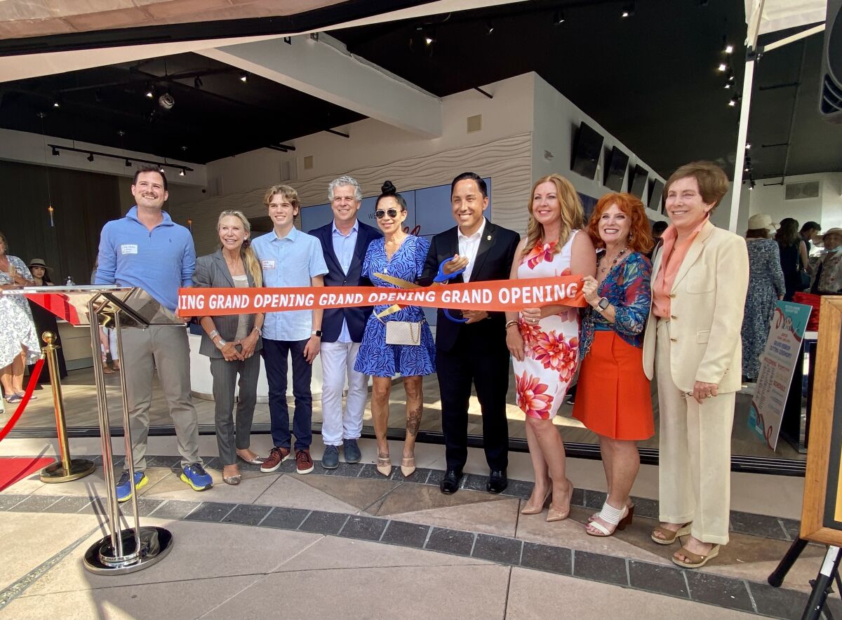 San Diego Mayor Todd Gloria cuts a ribbon along with several new La Jolla business owners in a June 15 ceremony.