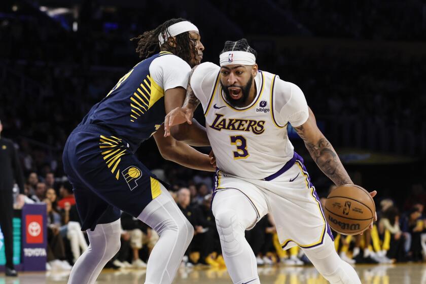 Los Angeles Lakers forward-center Anthony Davis (3) dribbles past Indiana Pacers.