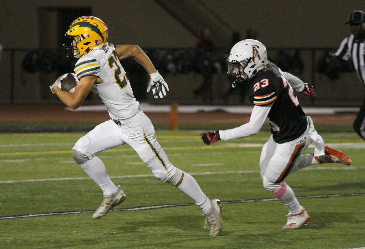 Edison's Nico Brown outruns Huntington Beach's Brandon Cascia and completes a 63-yard touchdown catch in the second quarter of a Sunset League game at Cap Sheue Field.