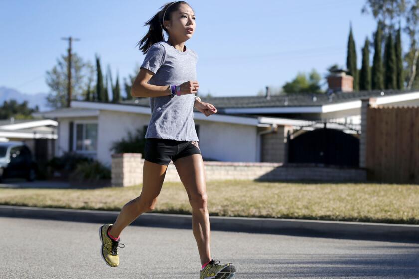 Lenore Moreno, a marathon runner, trains near her West Covina home on Tuesday before competing in the Olympic Trials Marathon this weekend.