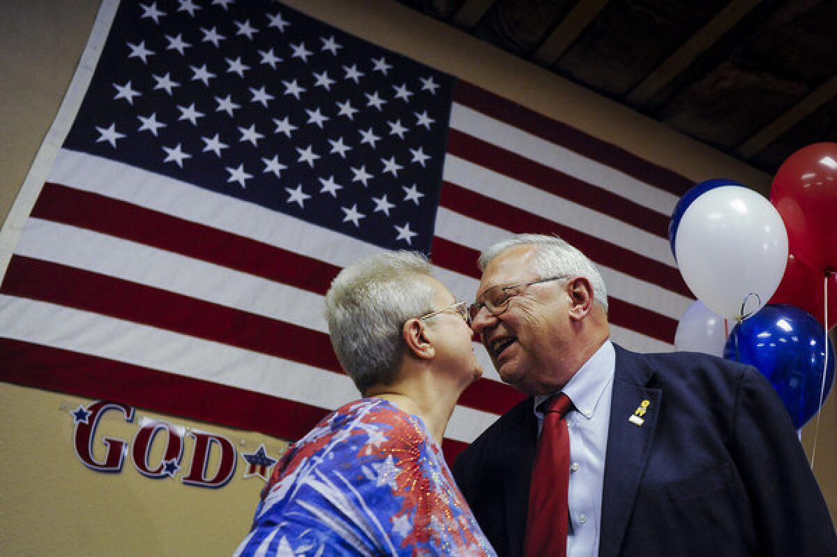 Bernie Herpin kisses his wife, Linda, as they celebrate his victory in the election to recall Colorado State Sen. John Morse.