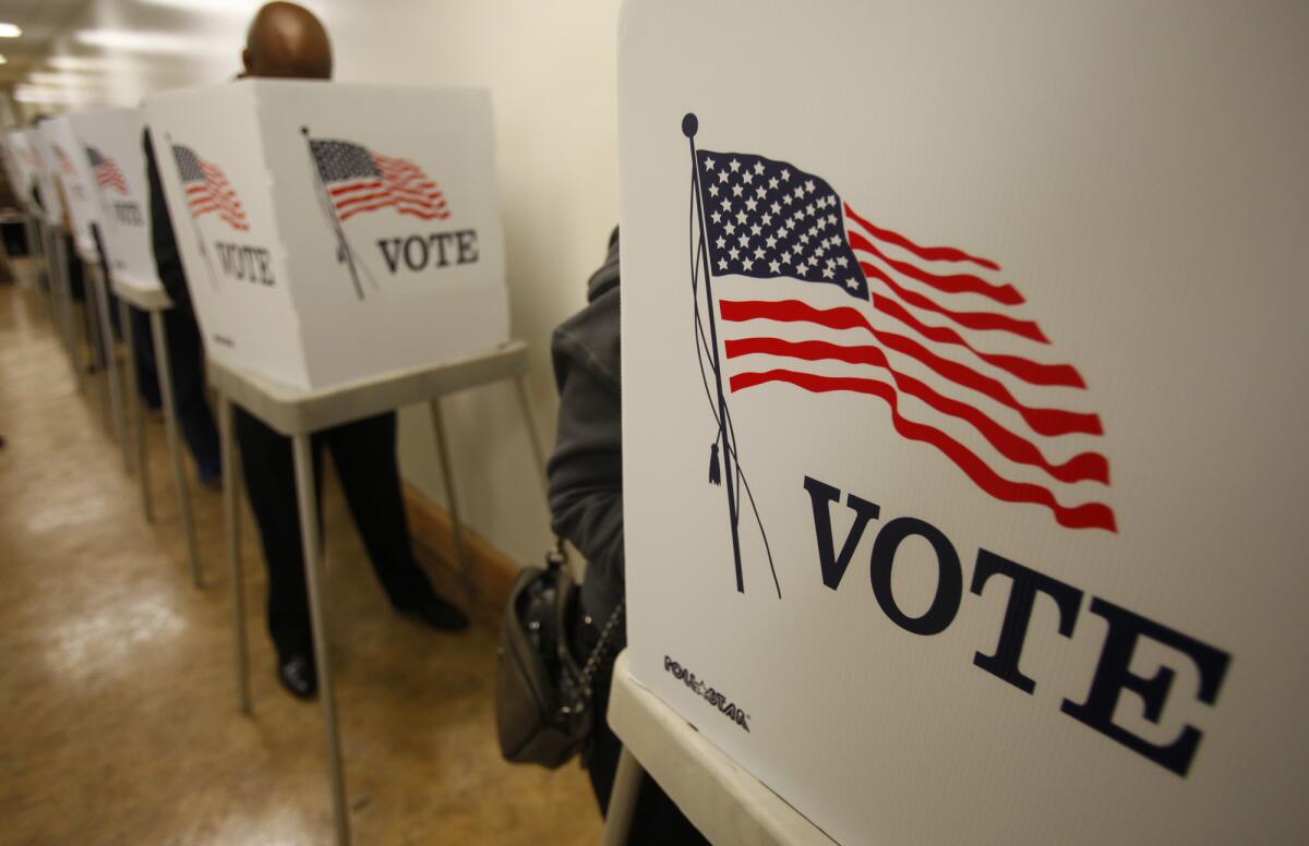 Voters fill out ballots at the Orange County Registrar's office in 2016.