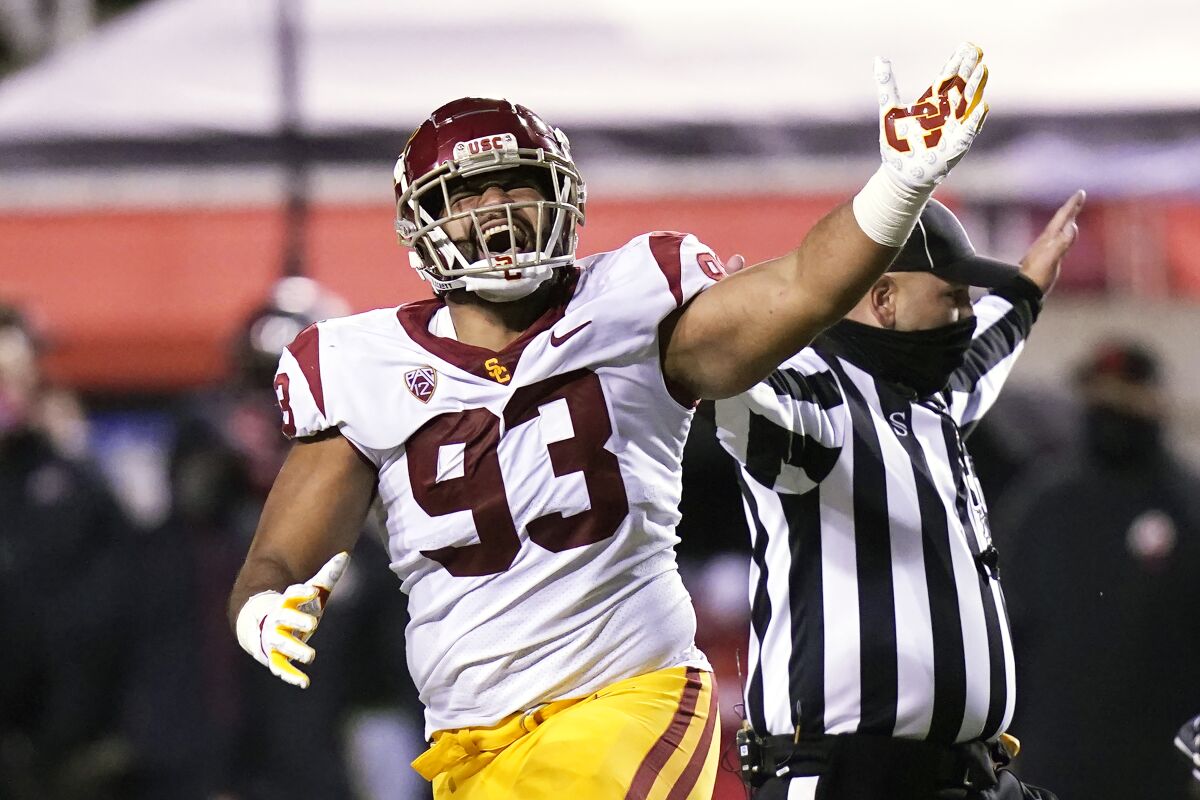 USC defensive lineman Marlon Tuipulotu celebrates after a fumble recovery.