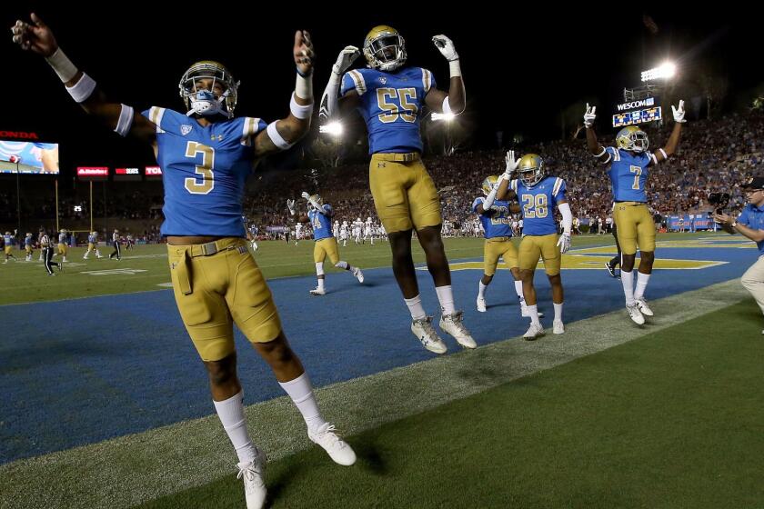 PASADENA, CALIF. - SEP. 3, 2017. Members of UCLA football team begin celebrating their 45-44 comeback victory over Texas A&M in the closing moments of the game on Sunday, Sept. 3, 2017, at the Rose Bowl in Pasadena. (Luis Sinco/Los Angeles Times)