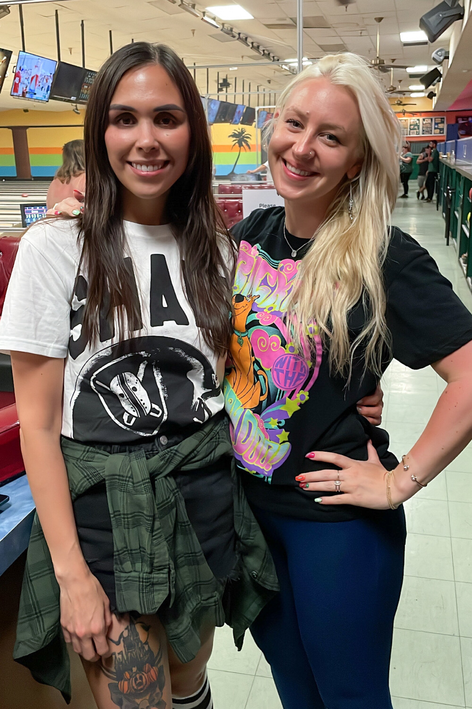 Two women at a bowling alley.