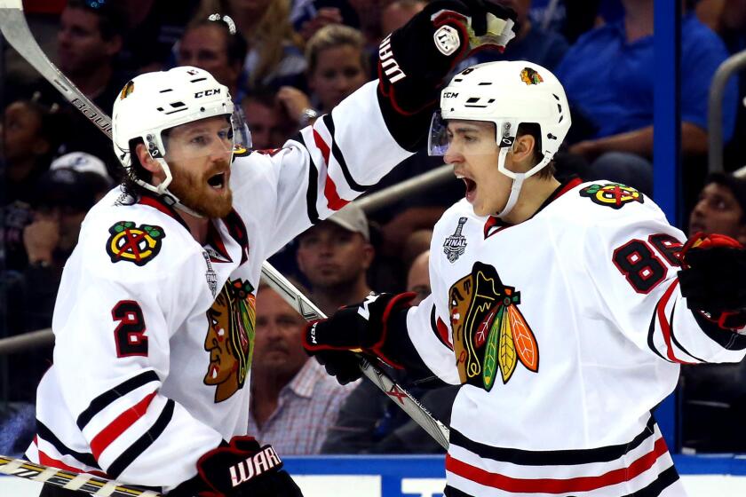 Blackhawks center Teuvo Teravainen (86) celebrates with defenseman Duncan Keith (2) after scoring against the Lightning in the third period of Game 1 of the Stanley Cup Final on Wednesday.