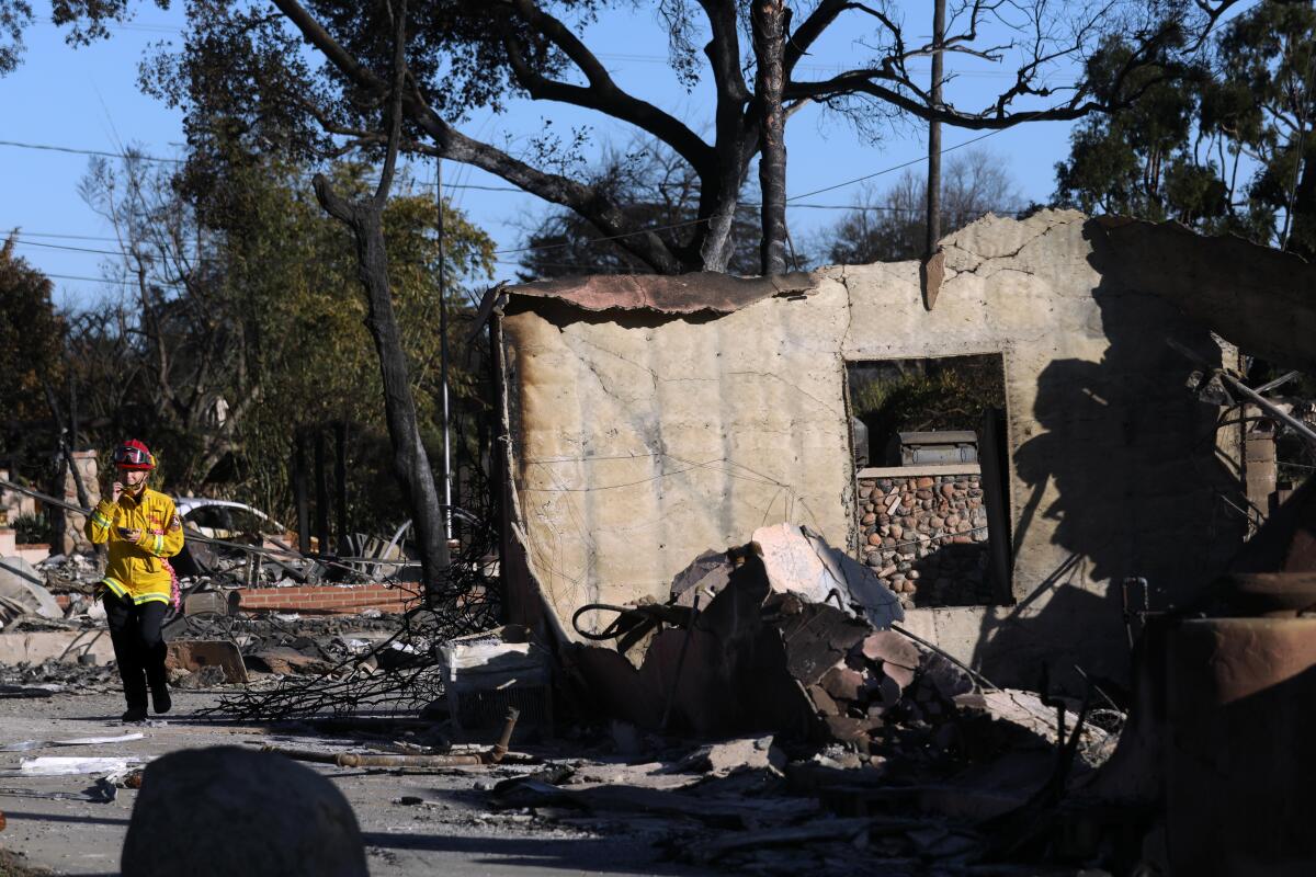 A Cal Fire official inspects fire damage.