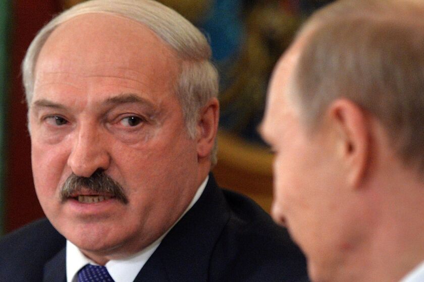 Belarus President Alexander Lukashenko, pictured here Tuesday with Russian President Vladimir Putin, criticized Moscow for imposing punitive curbs on Belarus exports.