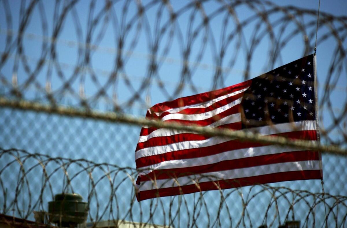 A U.S. flag flies over the United States Naval Station in Guantanamo Bay, Cuba.