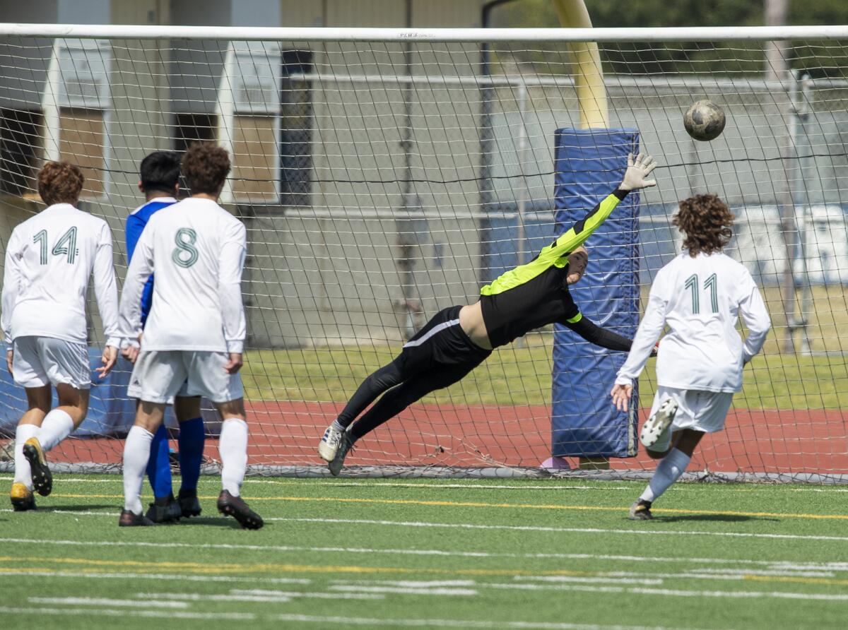 Fountain Valley's Connor Trapp stretches for a ball but comes up short on a goal by Edison's Trent Bellinger.