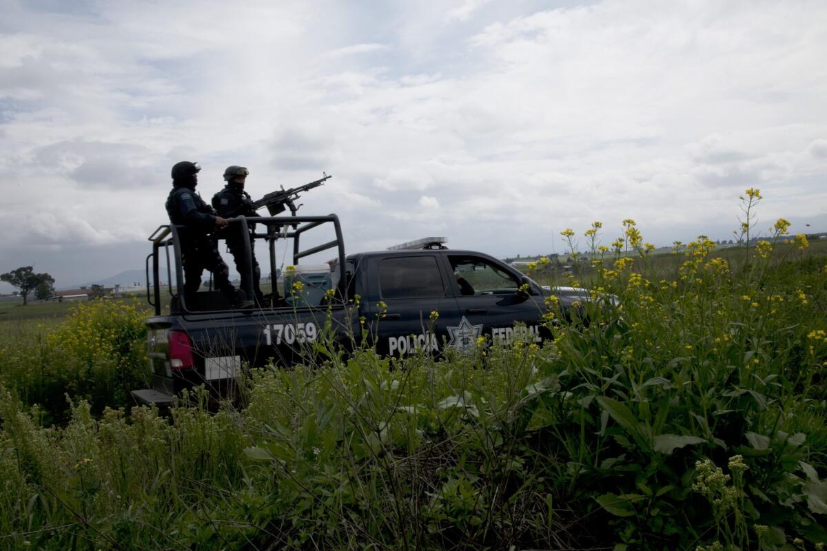 Mexican federal police near the Altiplano maximum security prison Sunday in Almoloya, Mexico. Joaquin "El Chapo" Guzman escaped from there -- it's the second time he's escaped imprisonment.