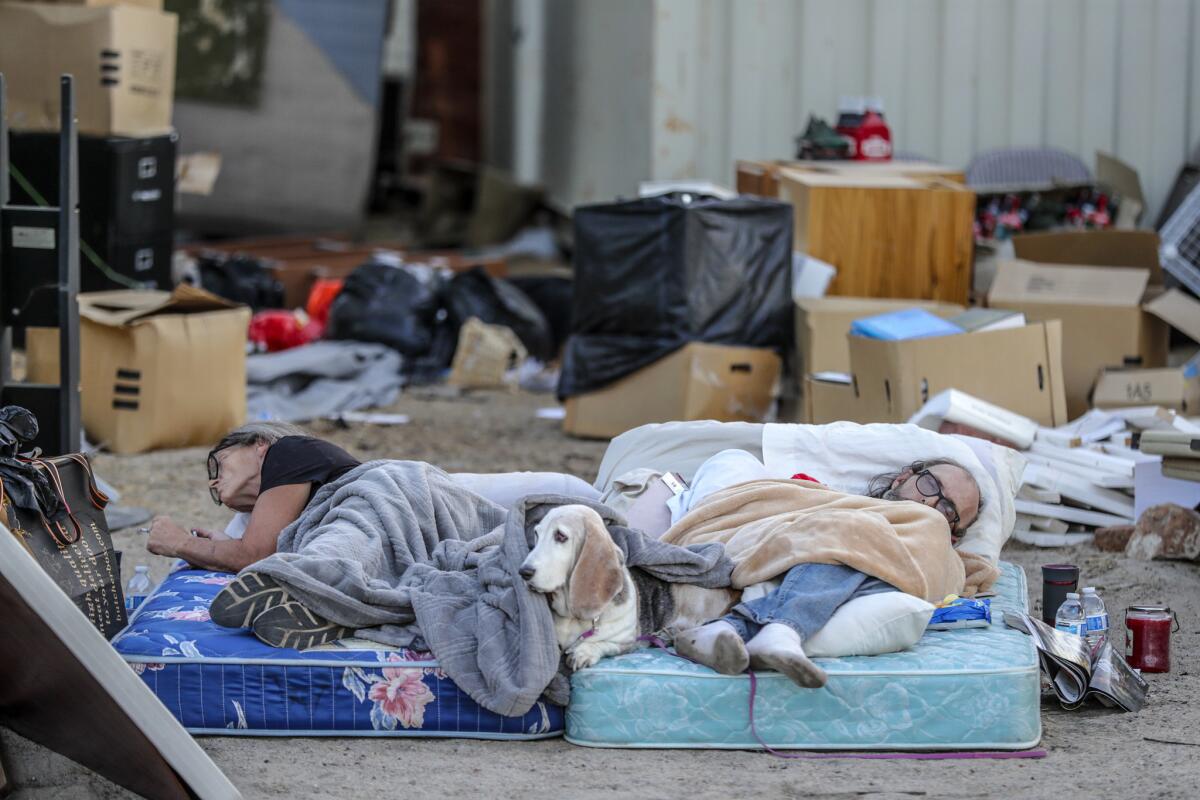 Ronnie Tolbert, left, and her husband, Danny, sleep on mattresses in the front yard of their Trona home, which was damaged in a 7.1 magnitude earthquake. (Robert Gauthier / Los Angeles Times)