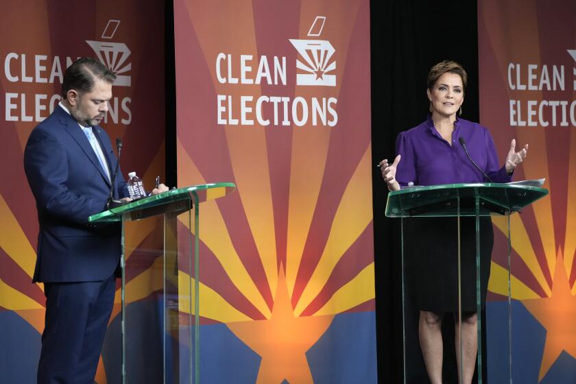 U.S. Senate candidates Rep. Ruben Gallego, D-Ariz., left, and Republican challenger Kari Lake participate in their debate, Wednesday, Oct. 9, 2024, in Phoenix. (Cheryl Evans/Arizona Republic via AP)