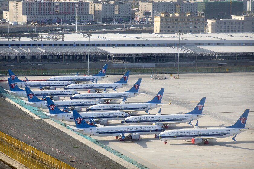 China Southern Airlines Boeing 737 Max airplanes are parked at the edge of the tarmac at Urumqi Diwopu Interational Airport in Urumqi in western China's Xinjiang Uyghur Autonomous Region, Wednesday, April 21, 2021. China's aviation regulator cleared the Boeing 737 Max on Thursday, Dec. 2, 2021, to return to flying with technical upgrades more than two years after the plane was grounded worldwide following two fatal crashes, a news outlet reported. (AP Photo/Mark Schiefelbein)