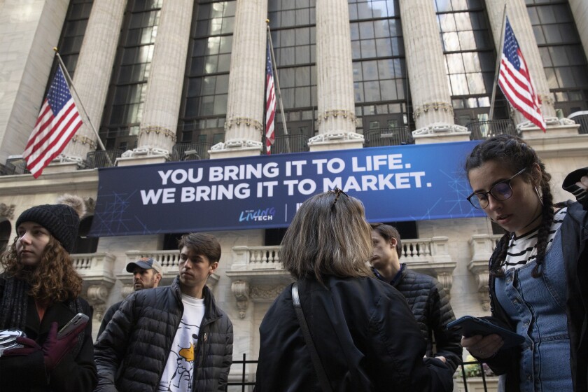 People pass the New York Stock Exchange on Monday. 