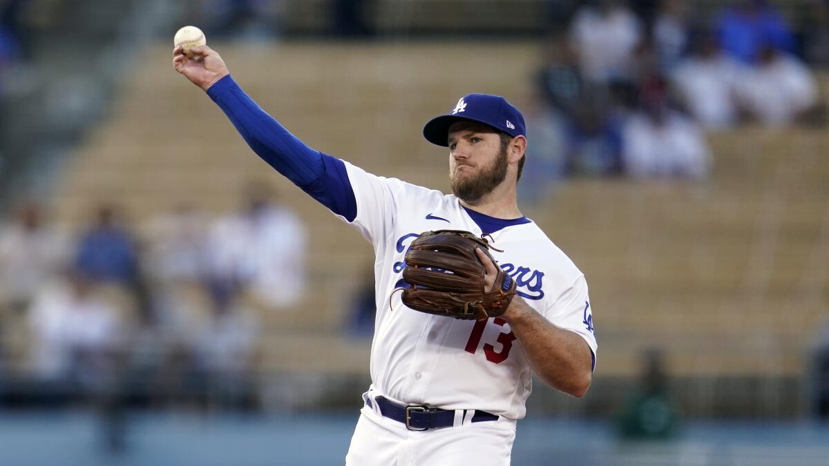 Los Angeles Dodgers' Max Muncy throws to first base during a baseball game.