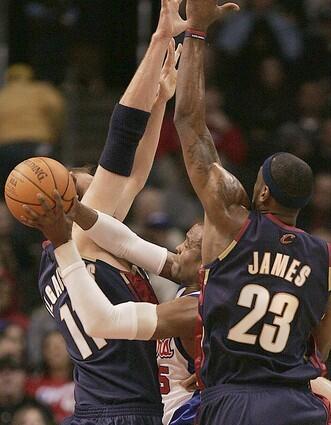 Clippers guard Cuttino Mobley is sandwiched by Cleveland Cavalier defenders Zydrunas Ilgauskas, left, and LeBron James.