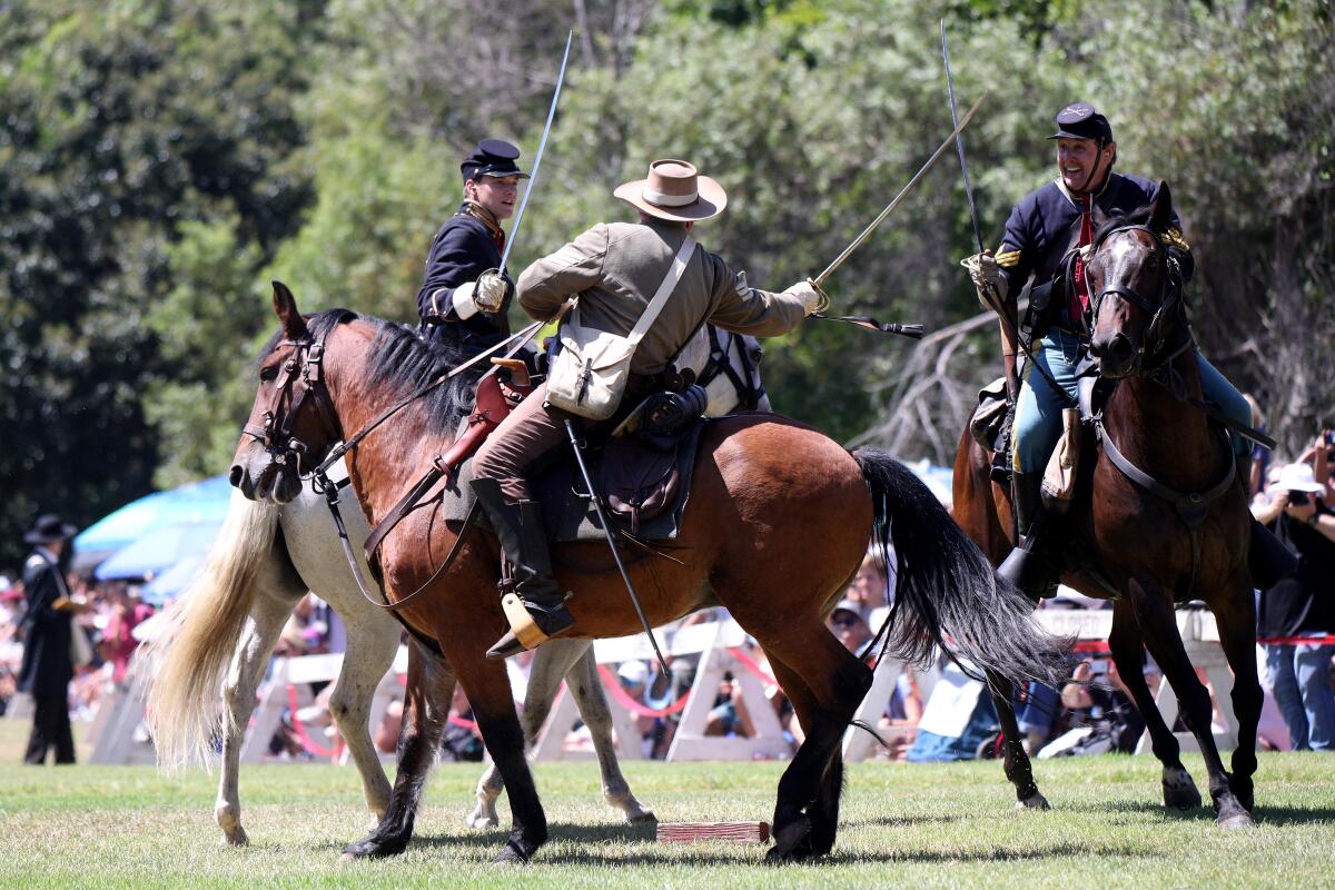 Two Union soldiers battle a rebel fighter at the Civil War Days reenactment in 2019.