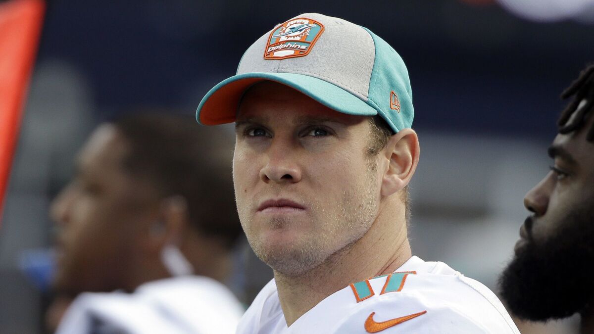 Dolphins quarterback Ryan Tannehill watches from the sideline during the second half of a game against the Patriots.