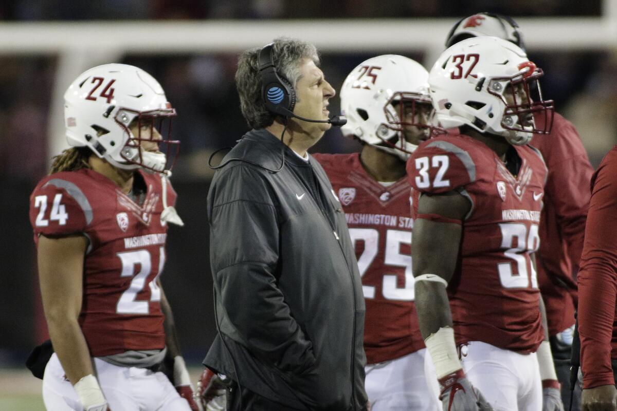Washington State Coach Mike Leach stands with his team during the second half of a game against California on Nov. 12.