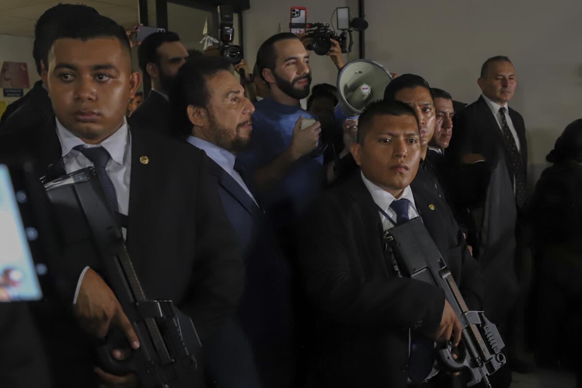 Members of the presidential security command surround El Salvador's President Nayib Bukele, center.