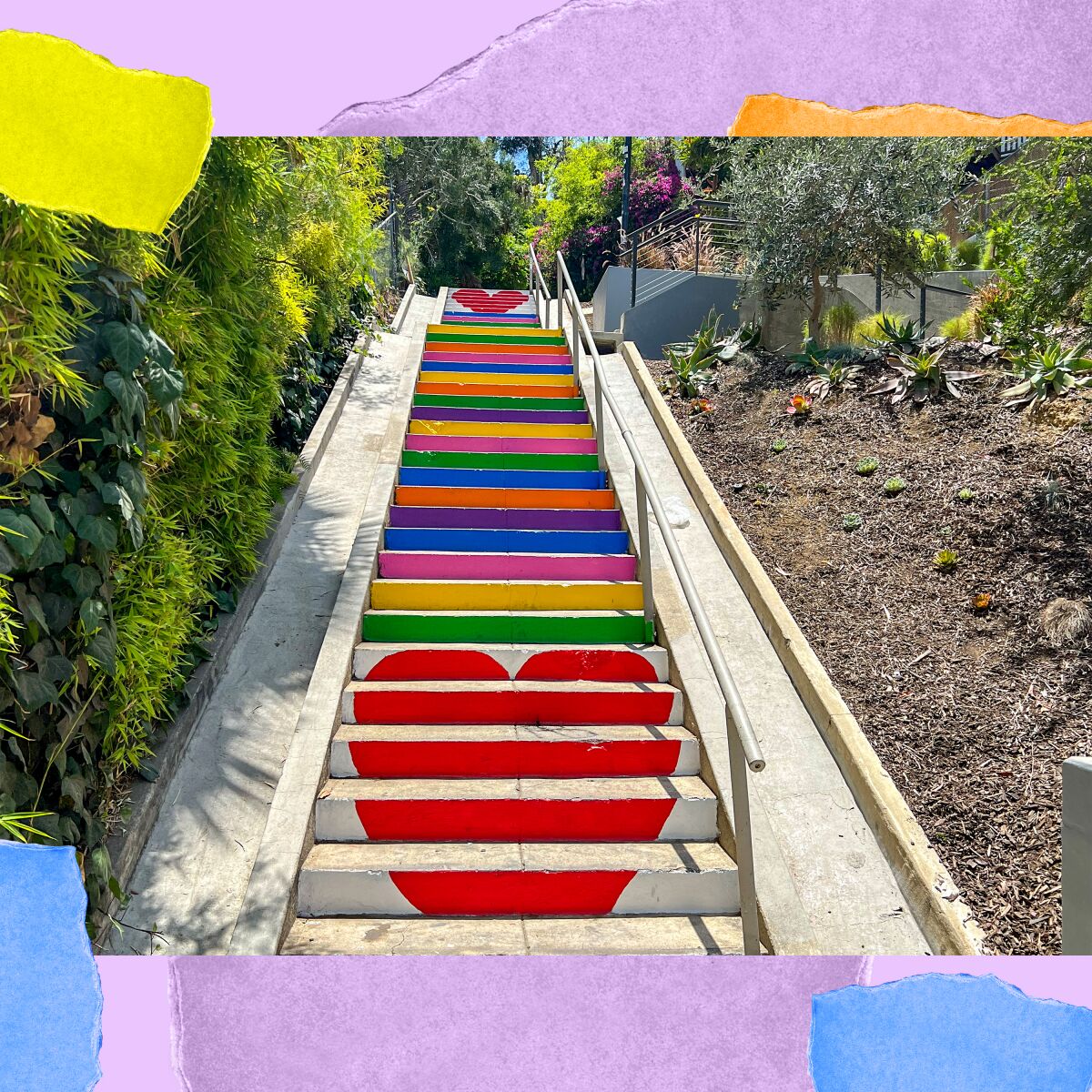 A set of outdoor concrete stairs that are painted with hearts and rainbow colors is seen from the bottom looking up.