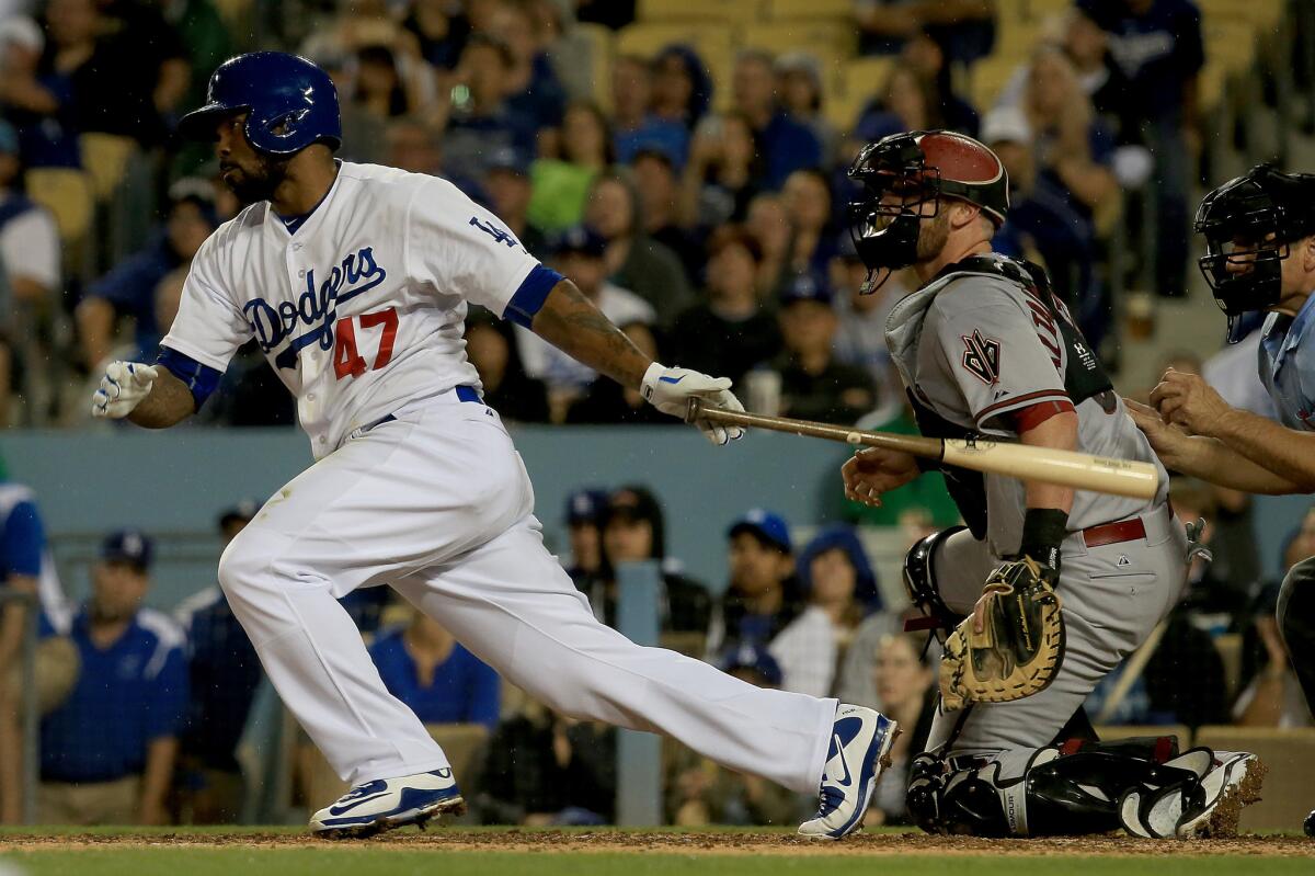 Dodgers second baseman Howie Kendrick hits a two-run single against the Arizona Diamondbacks in the seventh inning of a game Tuesday night at Dodger Stadium.