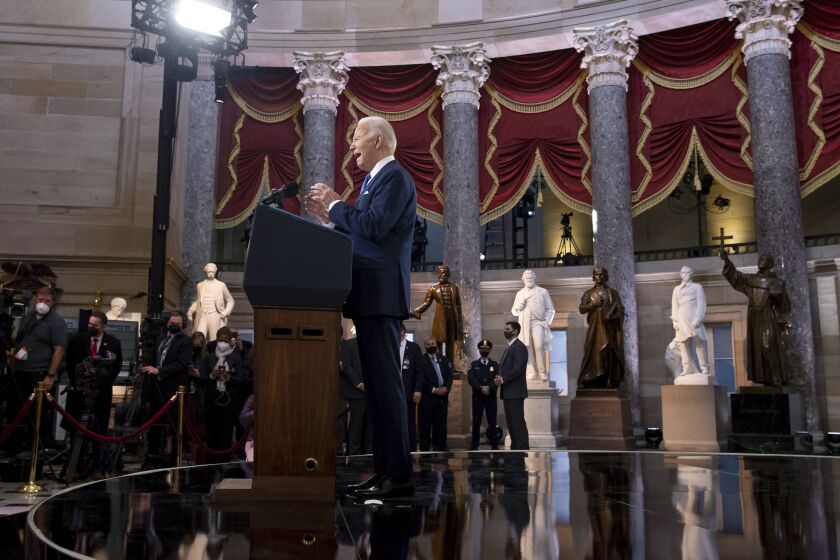 President Joe Biden speaks from Statuary Hall at the U.S. Capitol to mark the one year anniversary of the Jan. 6 riot at the U.S. Capitol by supporters loyal to then-President Donald Trump, Thursday, Jan. 6, 2022, in Washington. (Michael Reynolds/Pool via AP)