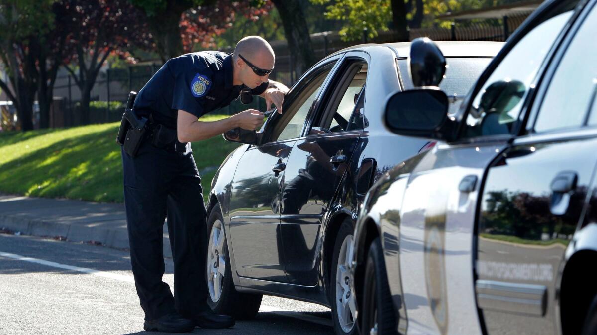 A Sacramento Police officer makes a traffic stop in November 2012. Gov. Jerry Brown signed a bill Tuesday to end the practice of Californians losing their driver's license because of unpaid traffic fines.