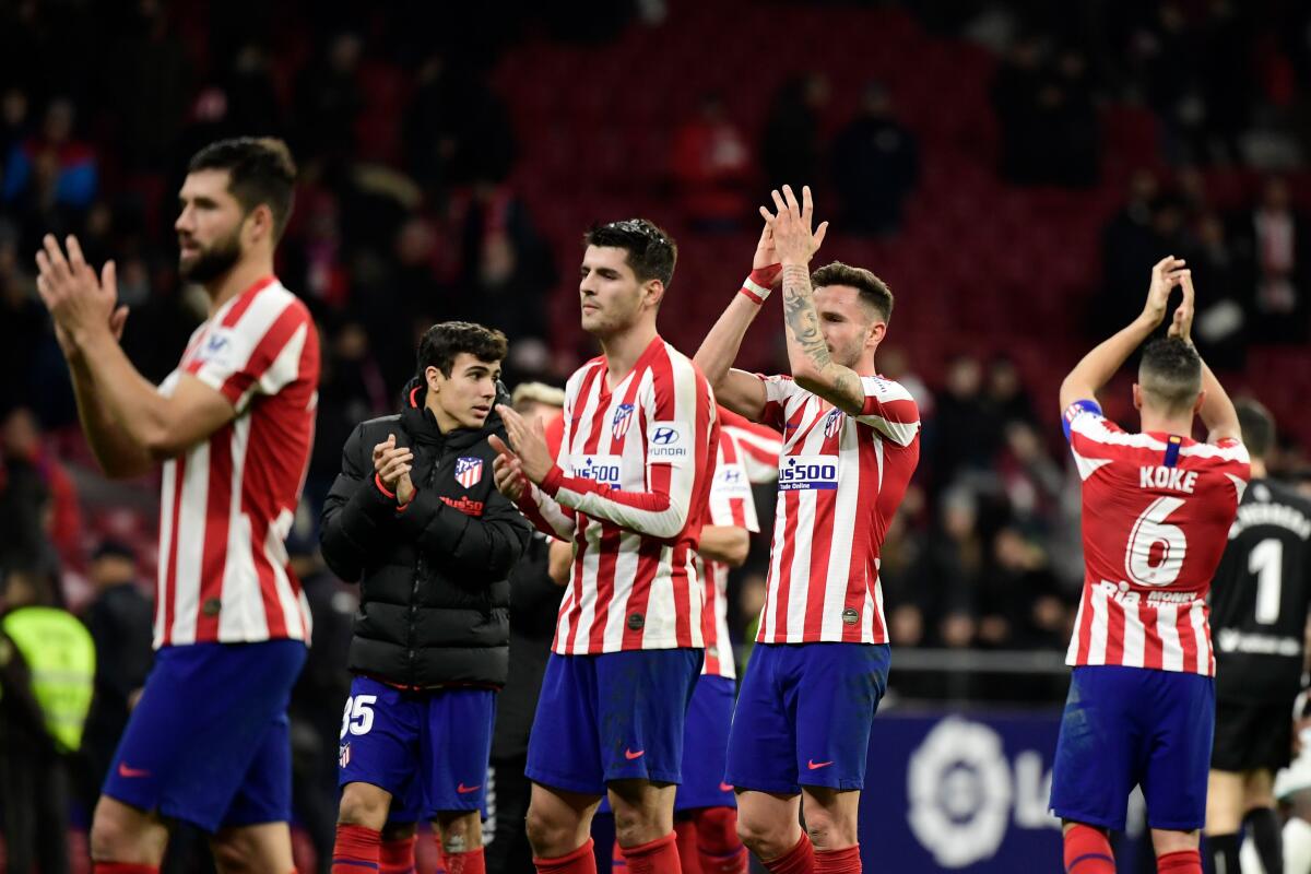 Atletico Madrid's players celebrate at the end of the Spanish League football match between Club Atletico de Madrid and CA Osasuna, at the Wanda Metropolitano stadium in Madrid on December 14, 2019. (Photo by CRISTINA QUICLER / AFP) (Photo by CRISTINA QUICLER/AFP via Getty Images) ** OUTS - ELSENT, FPG, CM - OUTS * NM, PH, VA if sourced by CT, LA or MoD **