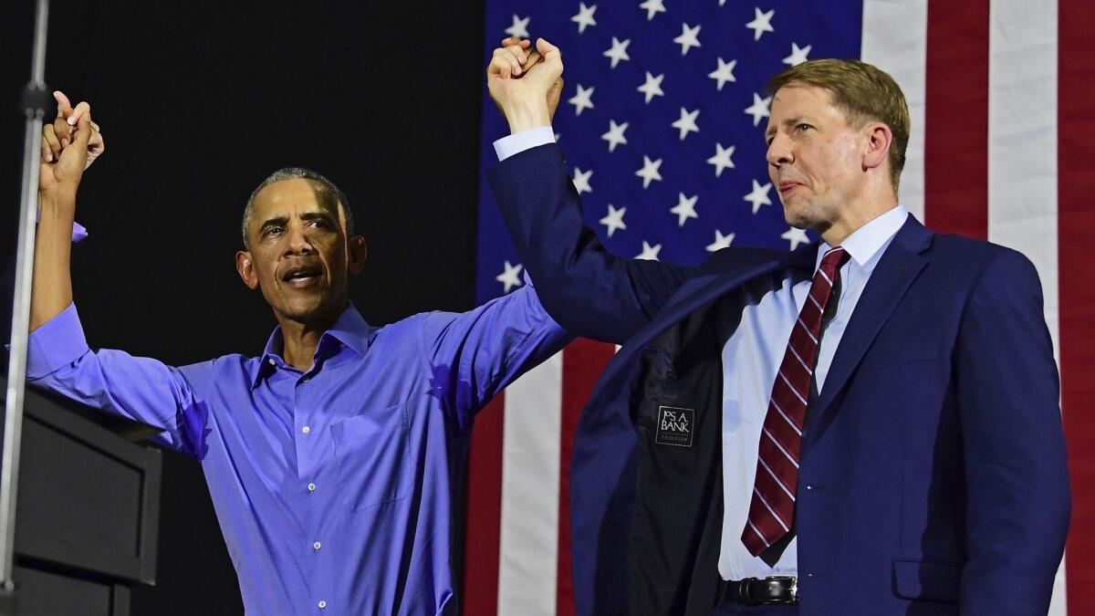 Ohio Democratic gubernatorial candidate Richard Cordray joins hands with former President Obama at a Sept. 13 campaign rally in Cleveland.