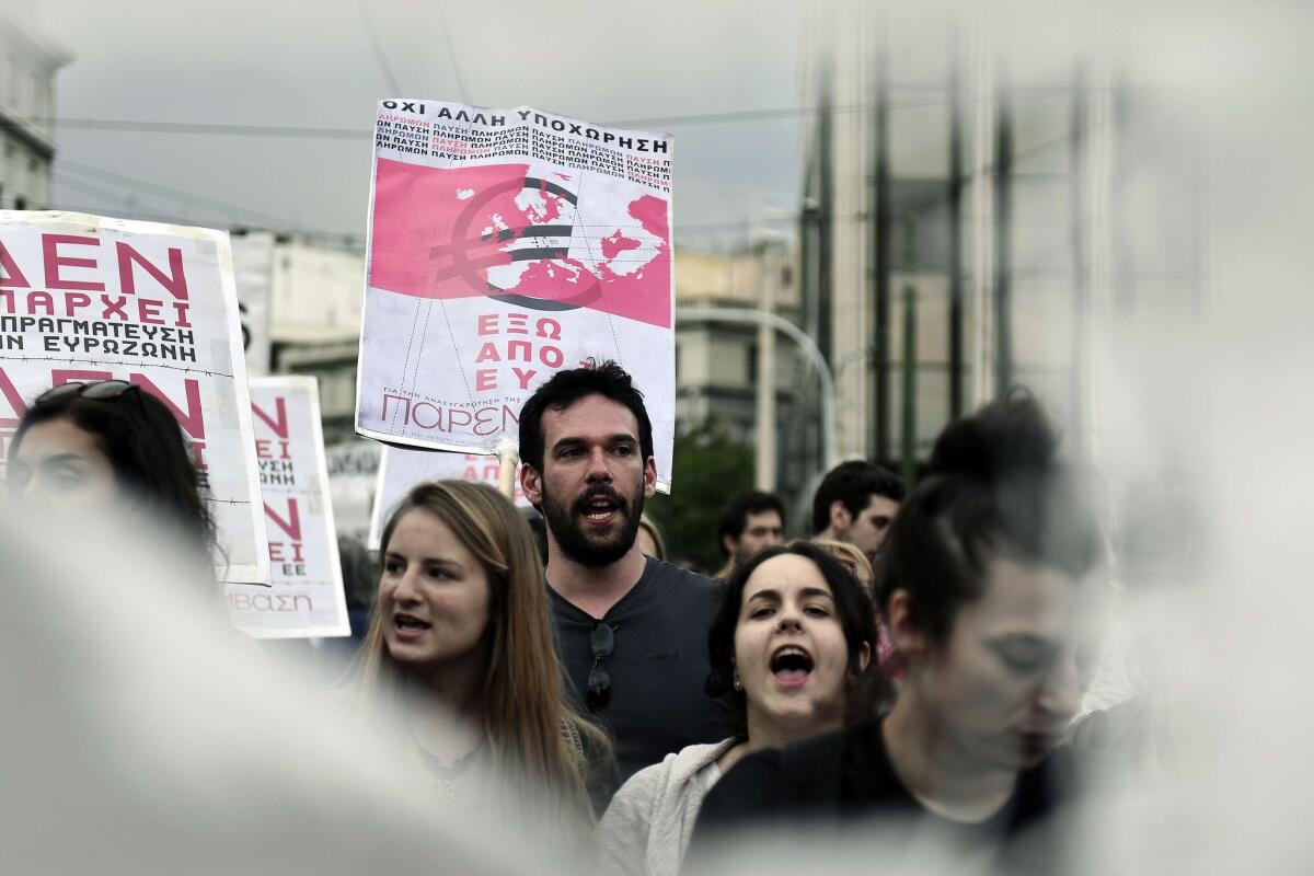 Leftist youth hold a placard reading, "No more recession, out of the Eurozone," during a demonstration in Athens calling for Greece's exit from the Eurozone.
