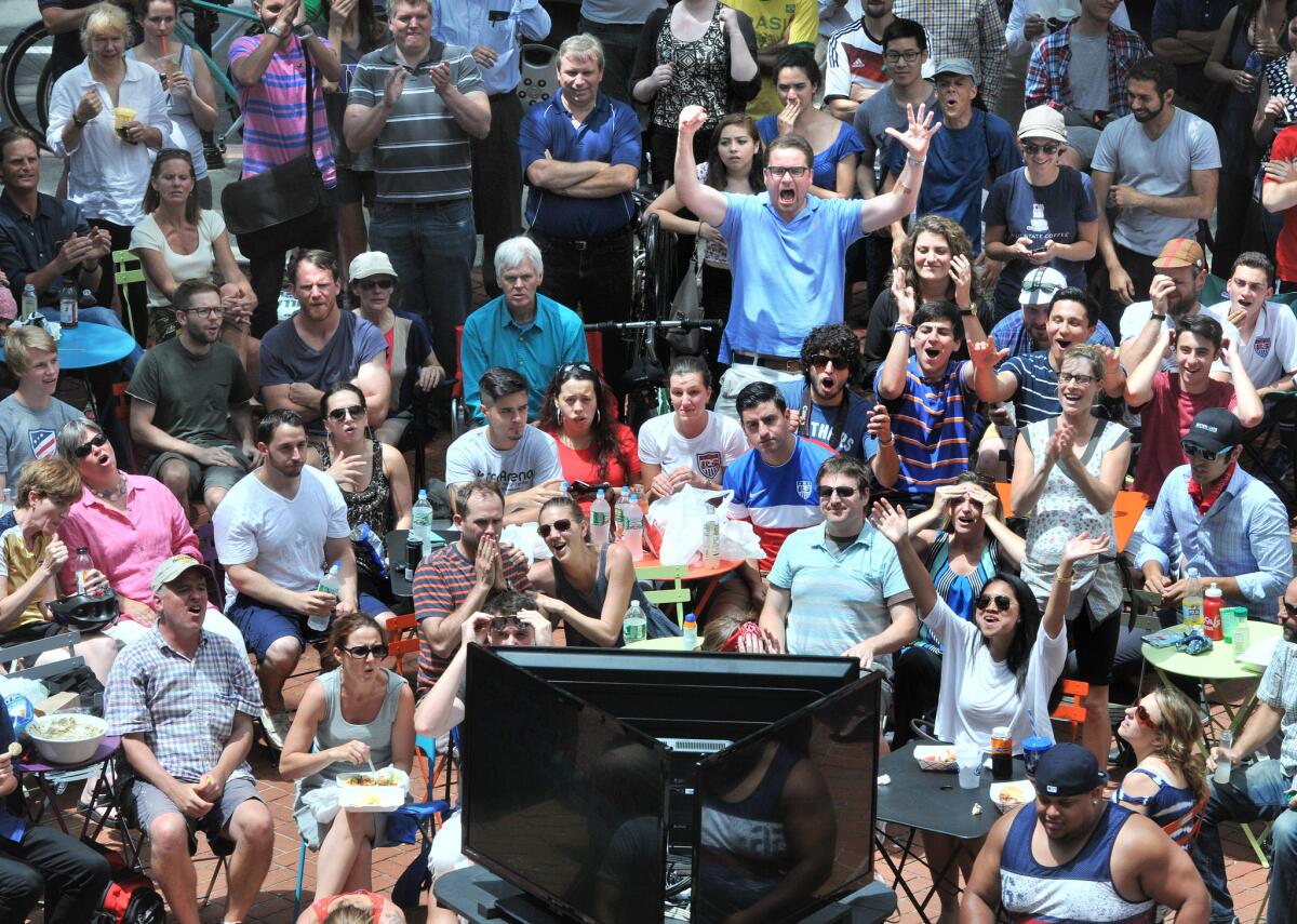 A few fans of Germany celebrate while watching a World Cup soccer match against the U.S. in Pitkin Plaza in New Haven, Conn.